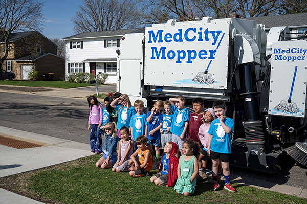 Students with a city sweeper