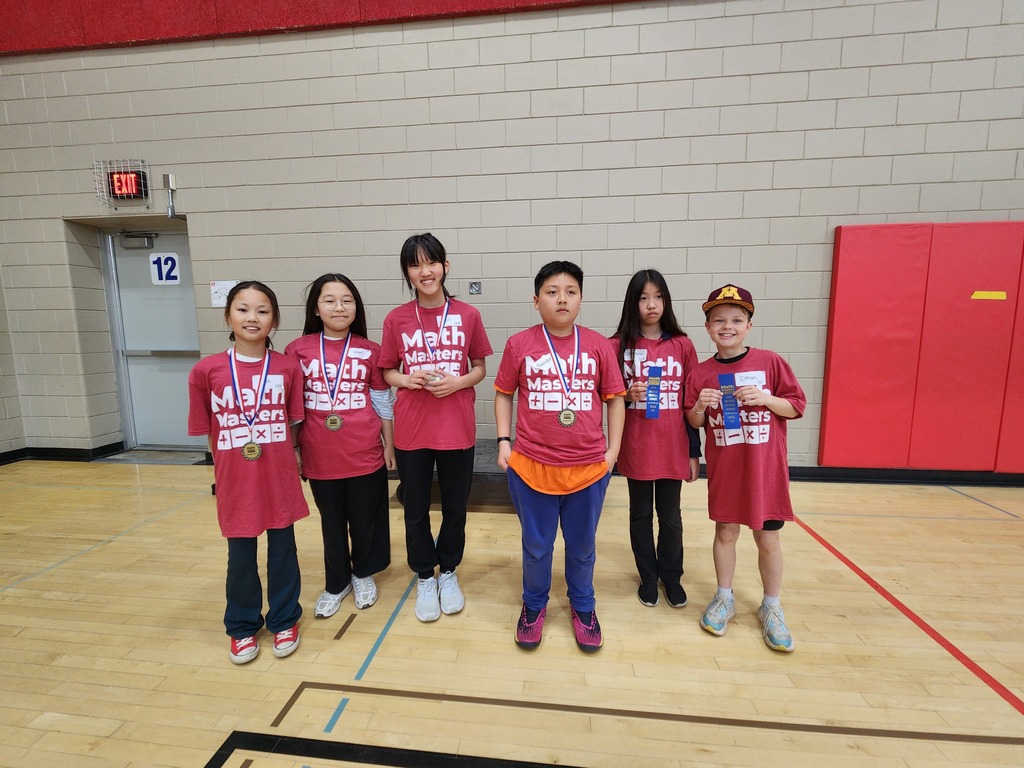 Washington Math Master students wearing awards medals and smiling at the camera or holding up their blue ribbons.