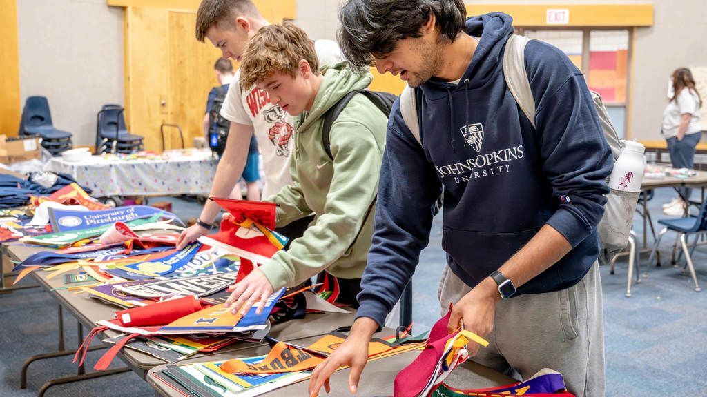 Seniors pick out pennants from the colleges they will attend next year.