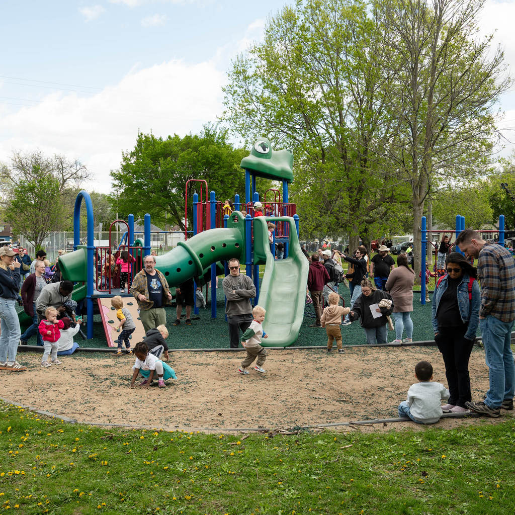 A crowded playground on a sunny day.