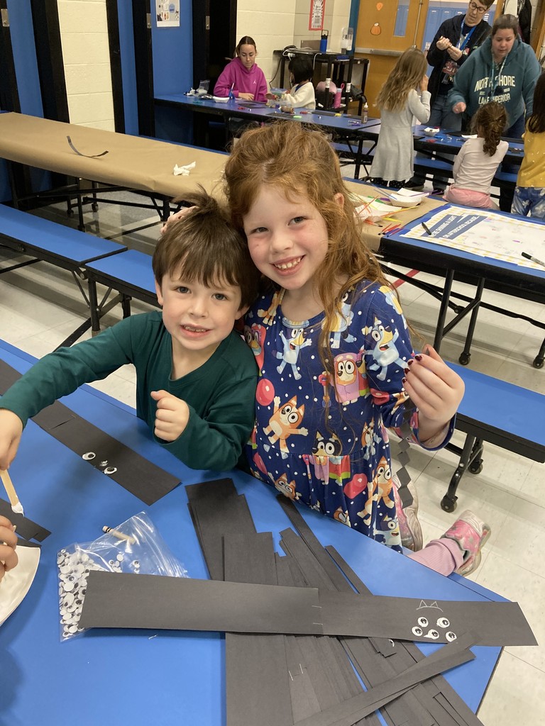 Two siblings at SACC doing an art activity.