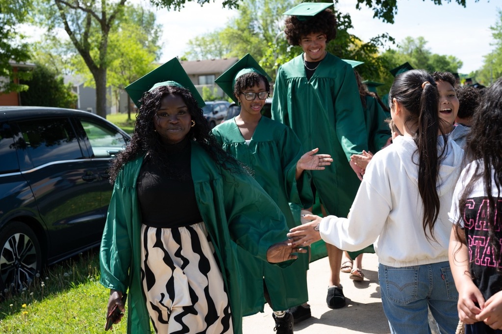 Three RPS seniors shaking the hands of 5th graders at Franklin while staring at the camera smiling.