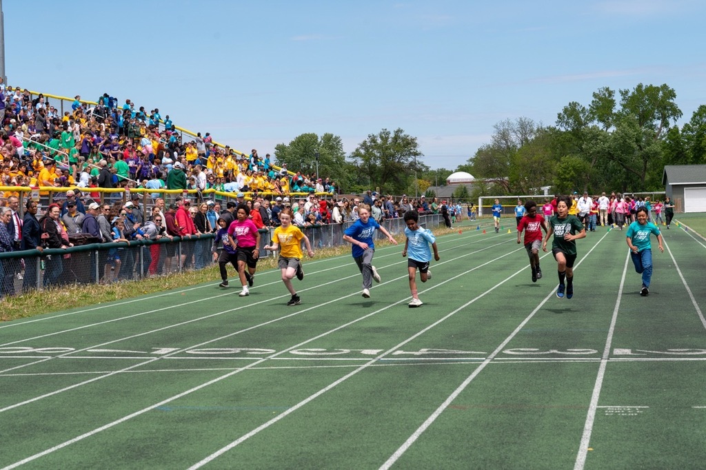 Students pushing forward to the finish line of the track.