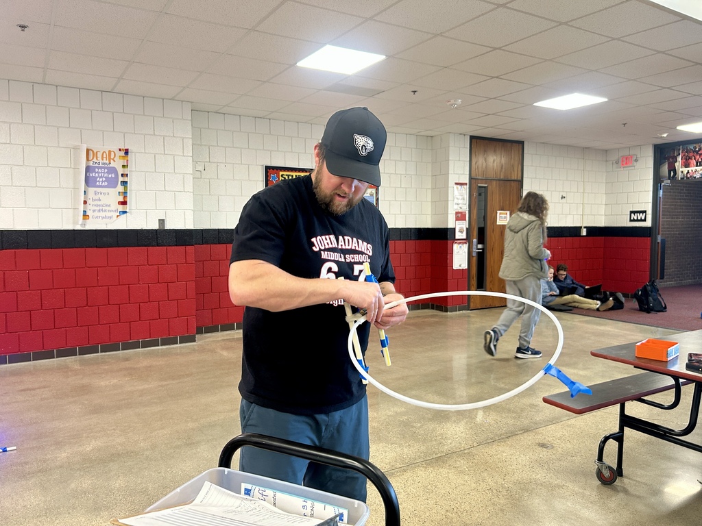 Drone club teacher lead Mr. Desart fixing equipment for student use
