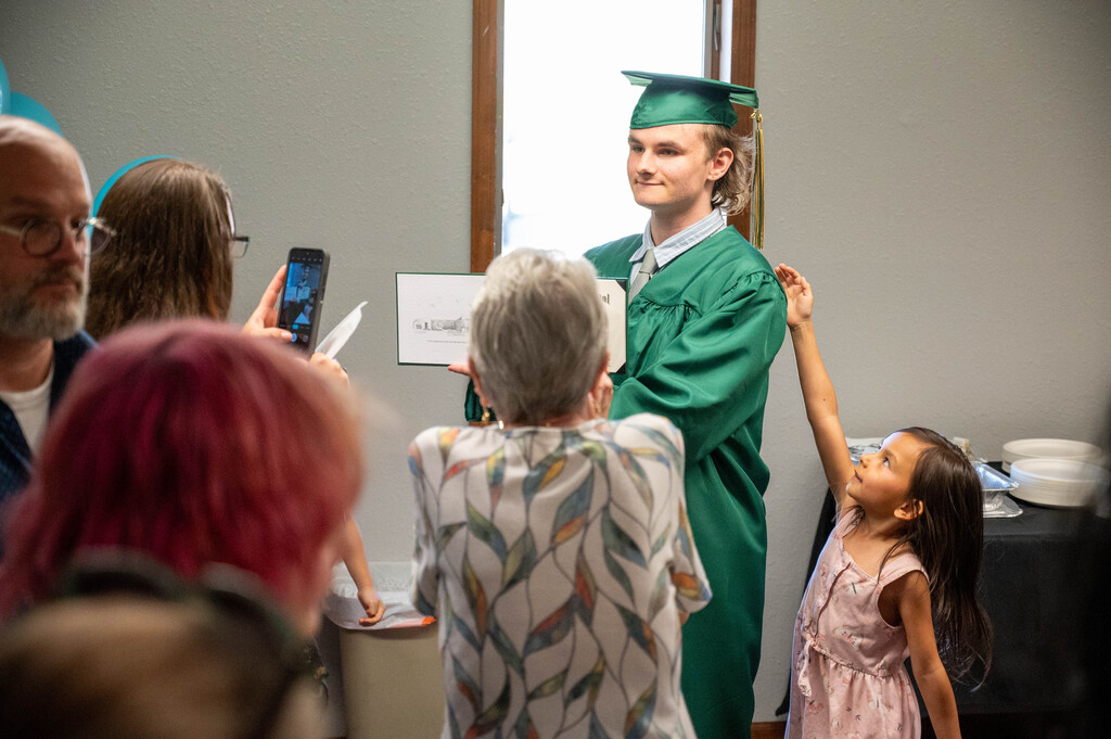 Leap Graduate poses with his diploma