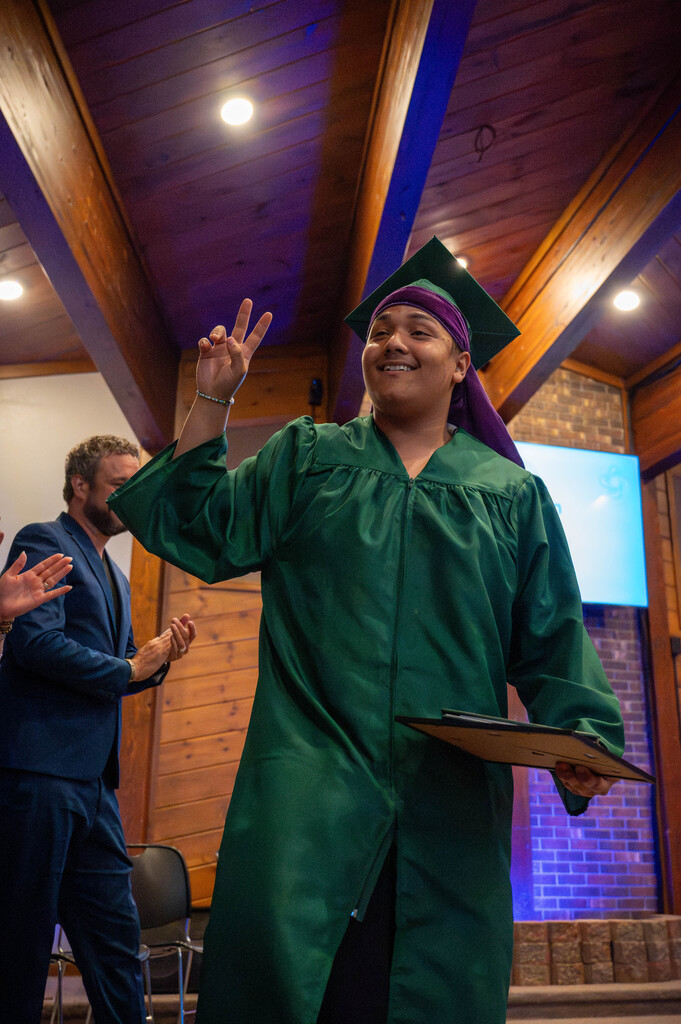 Leap Graduate poses with his diploma