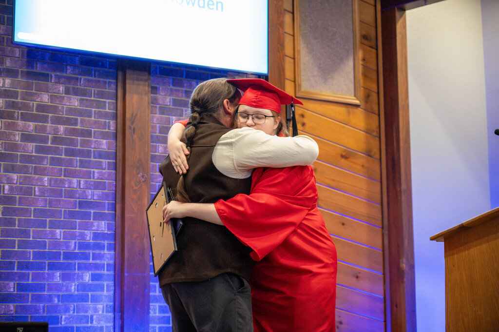 LEAP graduate embraces program coordinator Bucky Flores