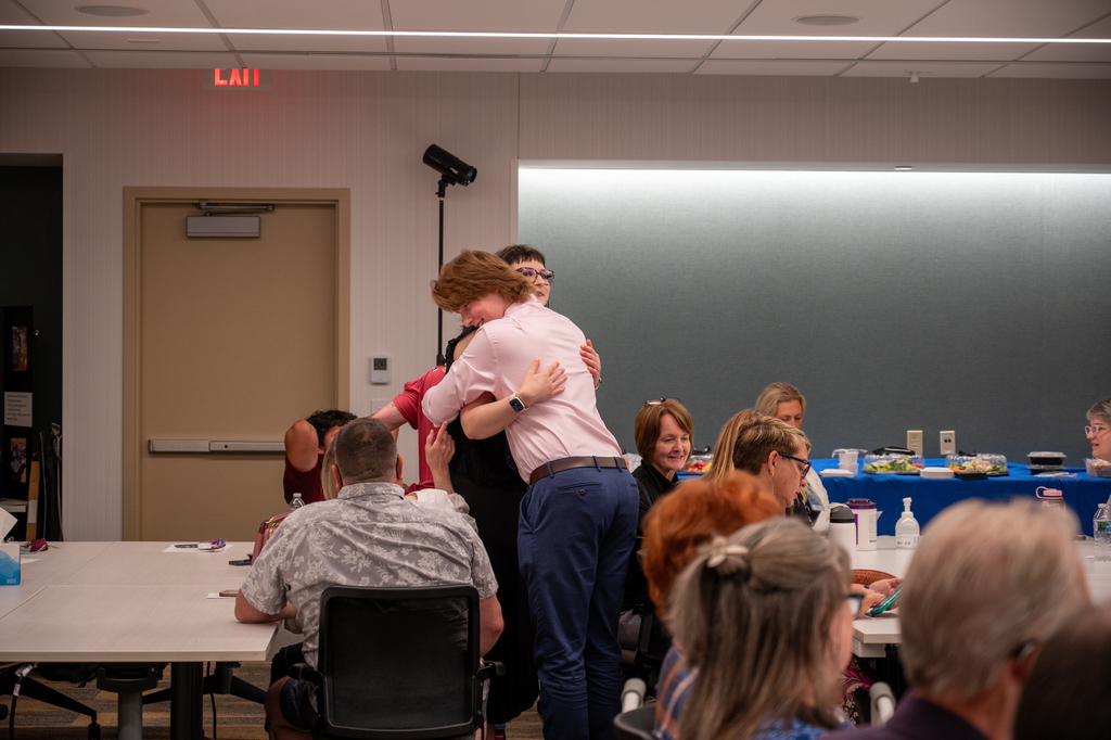 graduate hugging a family member