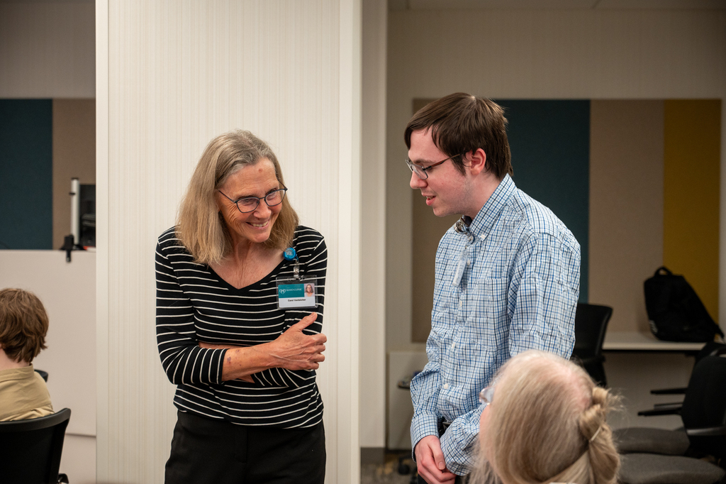 graduate talking with a staff person