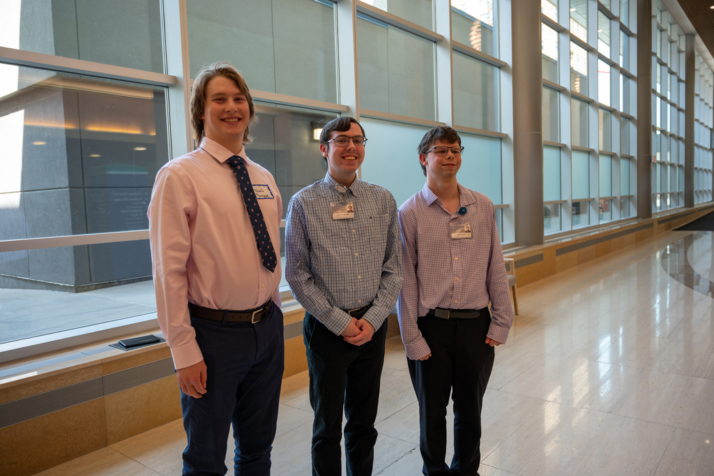 Three graduates smiling at camera
