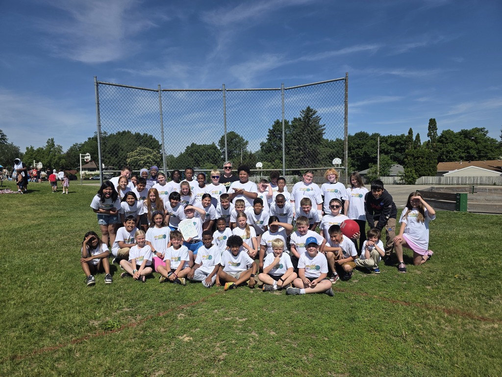 students in whit t-shirt with Mr. Pekel