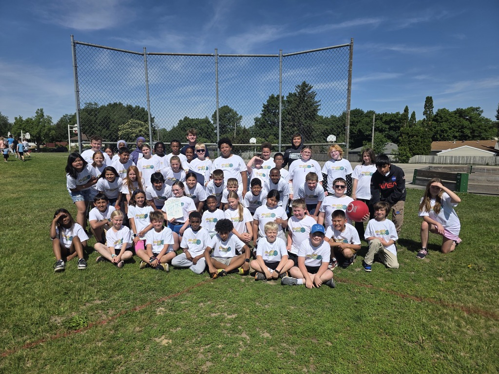 Students in white t-shirt with Mr. Pekel and Rochester Honker players.