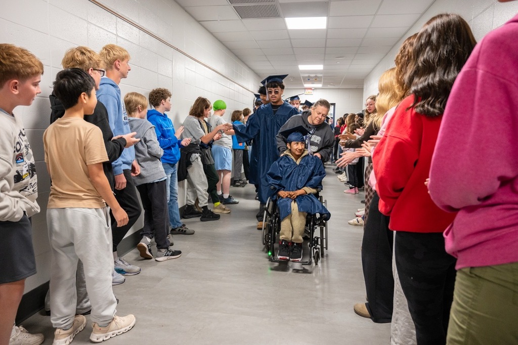 Century senior being wheeled down the hallway to celebrate graduation