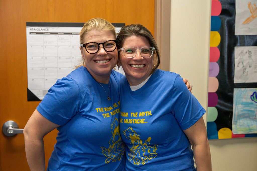 Two adults in blue shirts