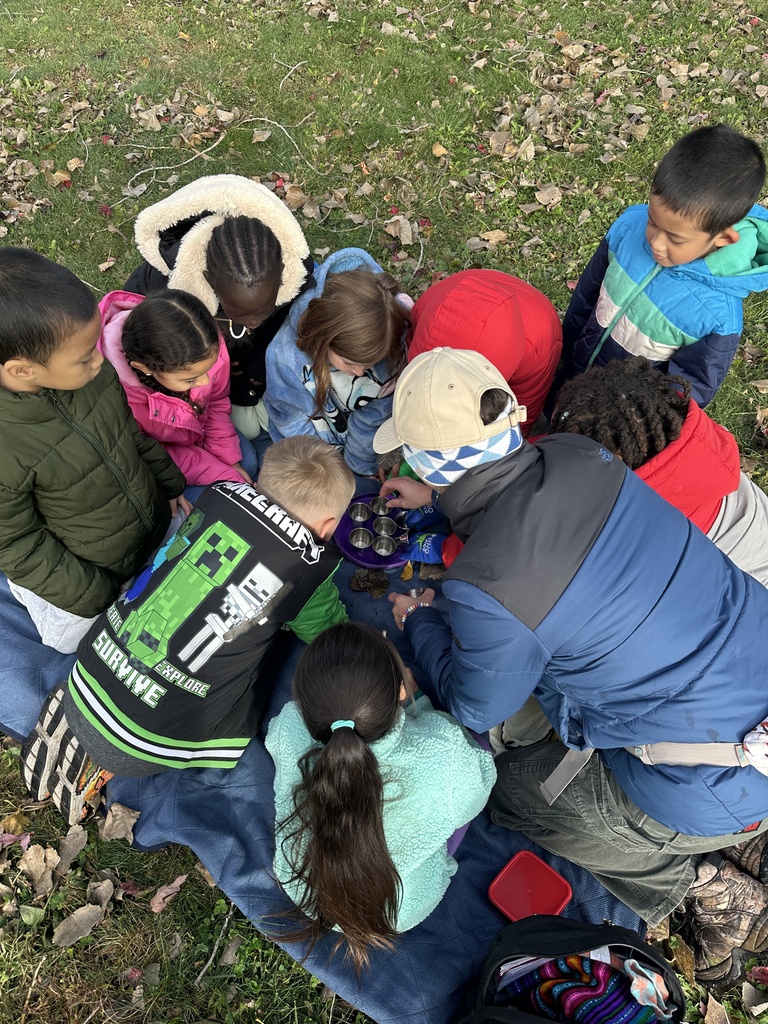 Children and adult gathered around a tea party