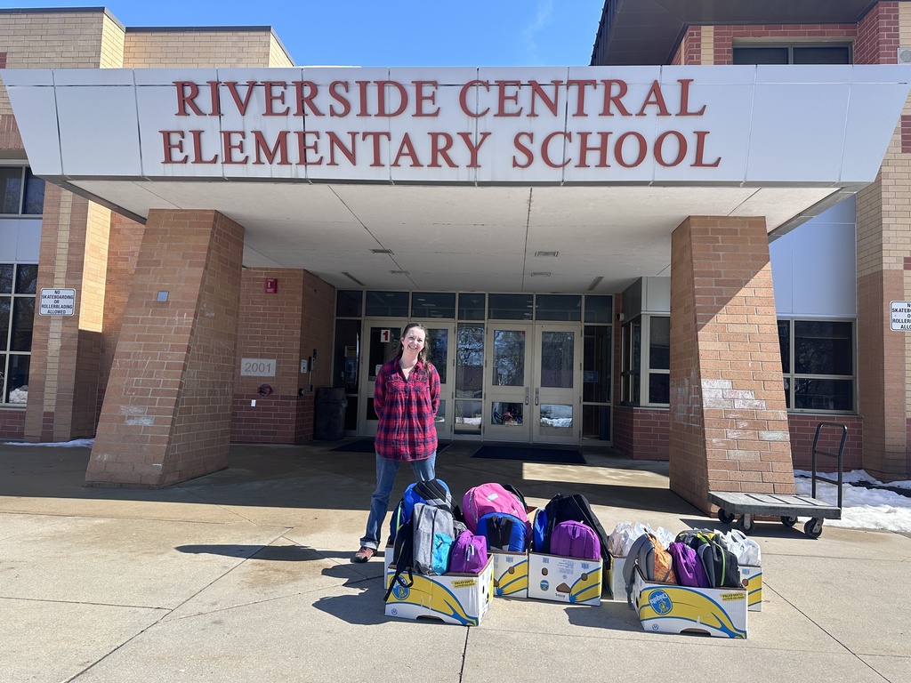 Adult standing with backpacks