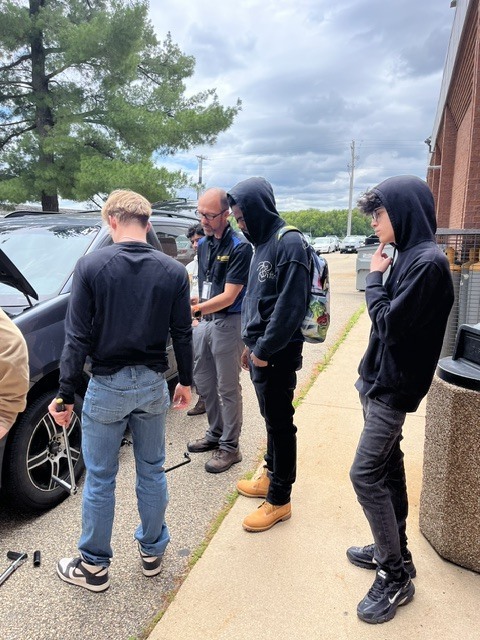 auto class learning about changing a tire