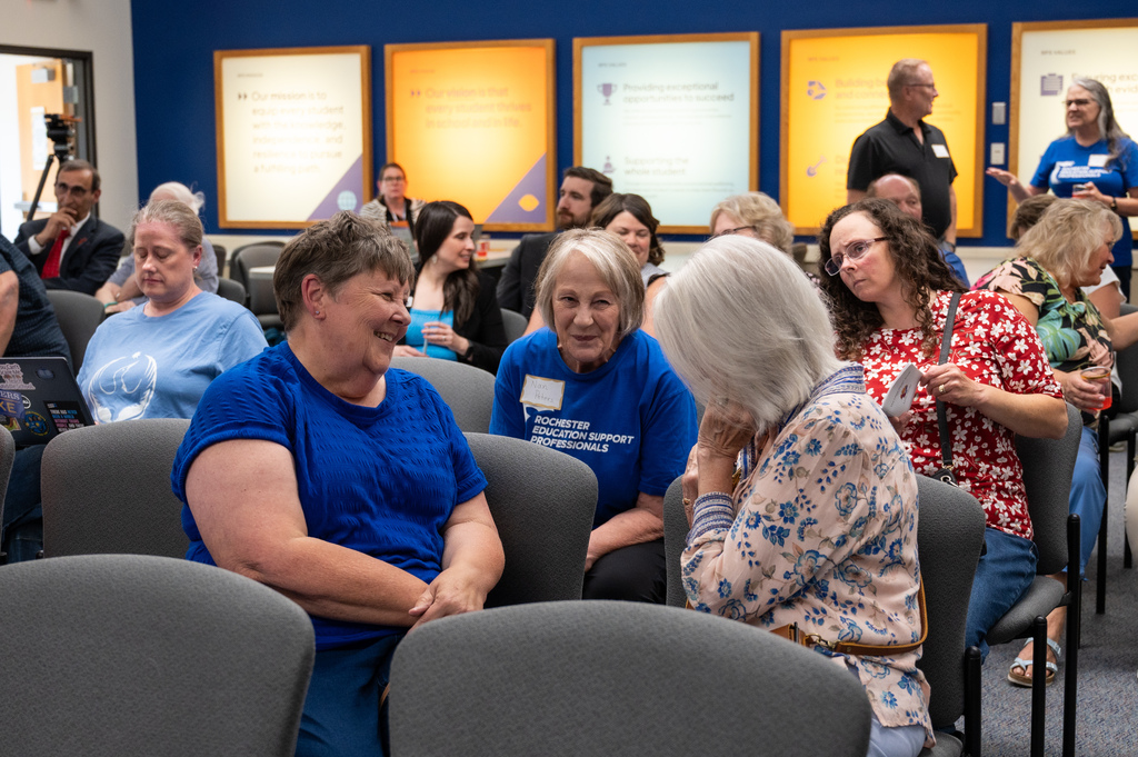 Friends of retirees talking together and smiling.