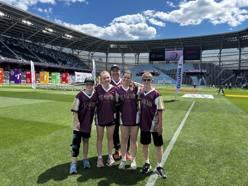 Five students wearing Team MN Special Olympic jerseys.