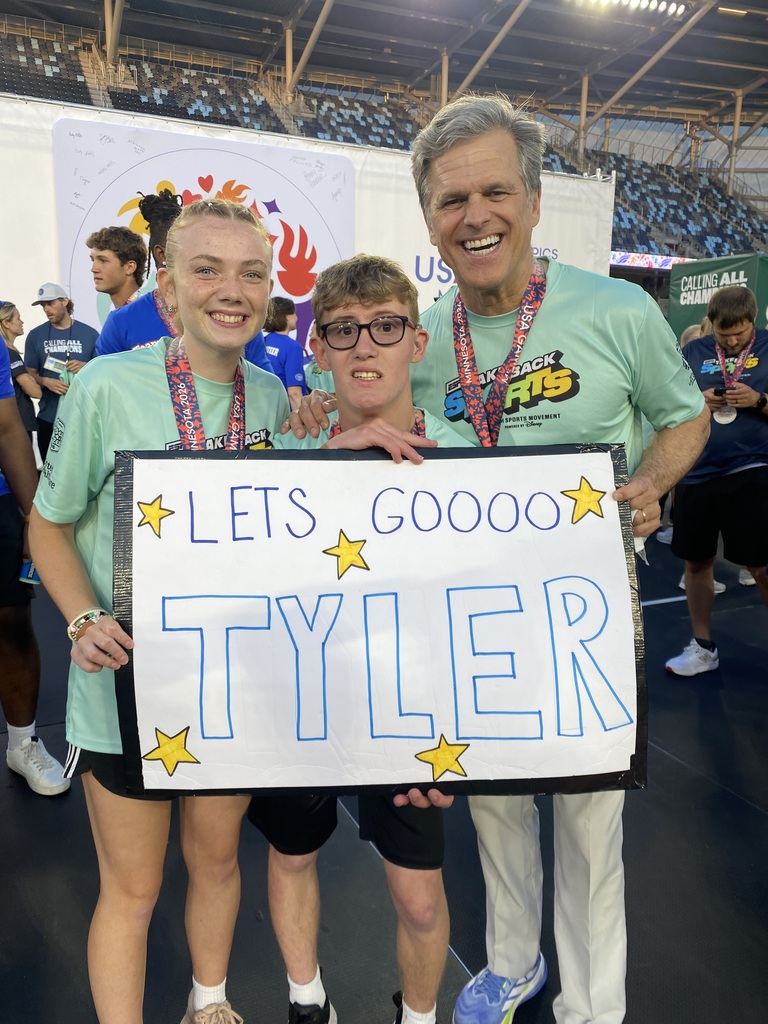 Group of students wearing Take Back Sports shirts and a sign that states "Let's Go Tyler".