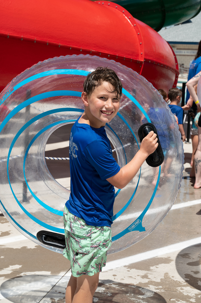 Student holding a tube getting ready to get back in the lazy river.