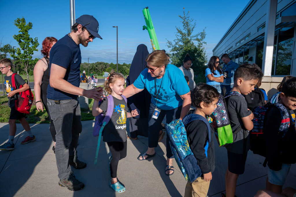 A Longfellow student is ushered into line with her new classmates