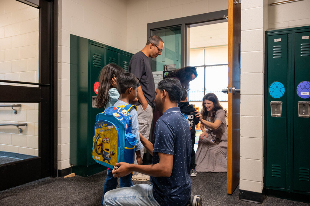 A group of two families getting ready to meet the teacher on our Step Into Learning Days.