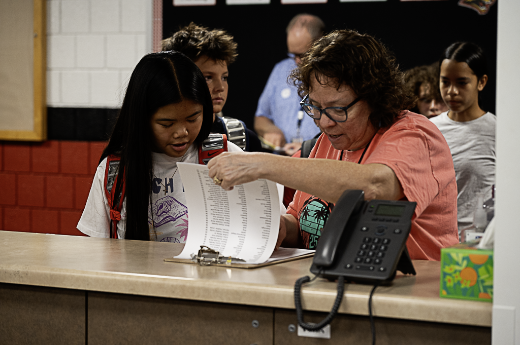Attendance staff helping student find their information for first hour at the attendance window