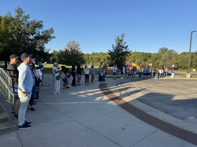 Parents clapping in students