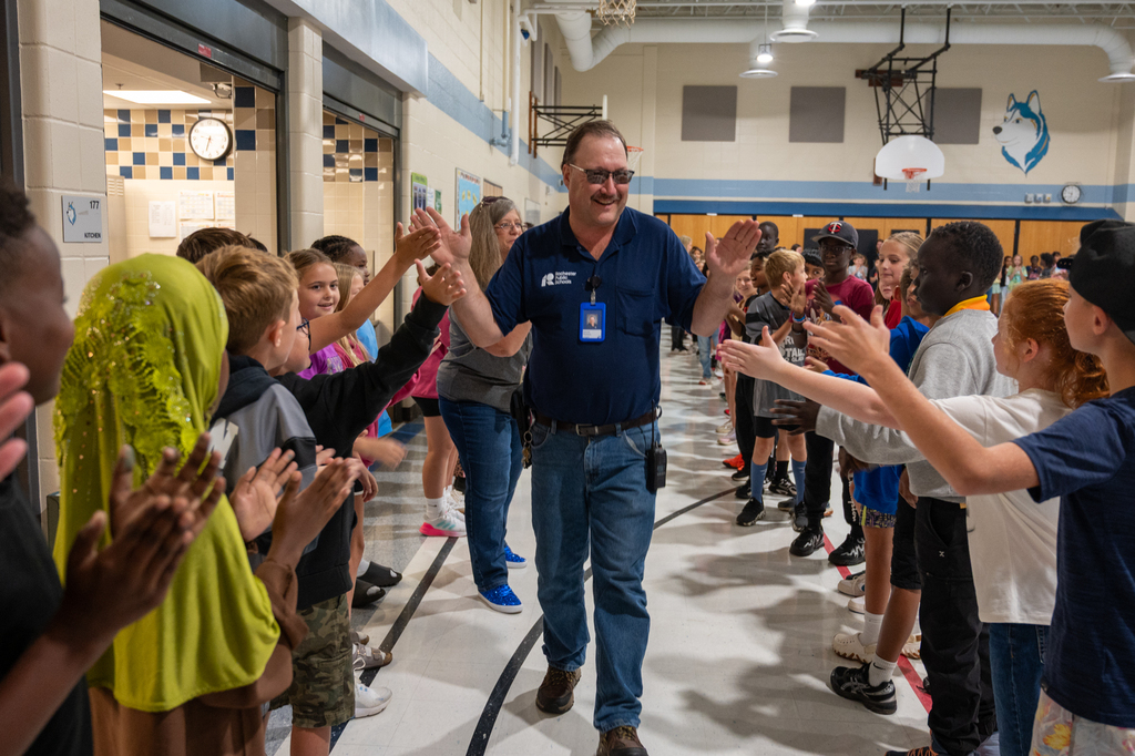 Mr. Denny receiving high fives