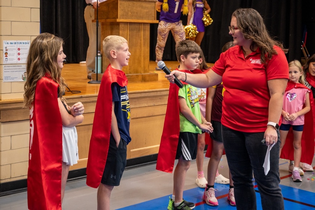 AHA member interviewing a student with a mic.