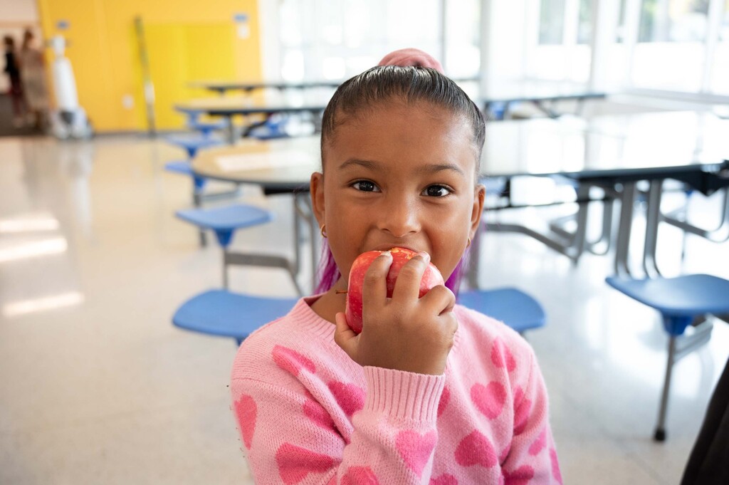 Student crunching into an apple