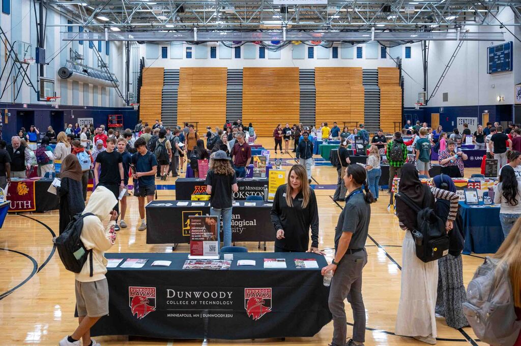 In a gym tables are set for the college fair