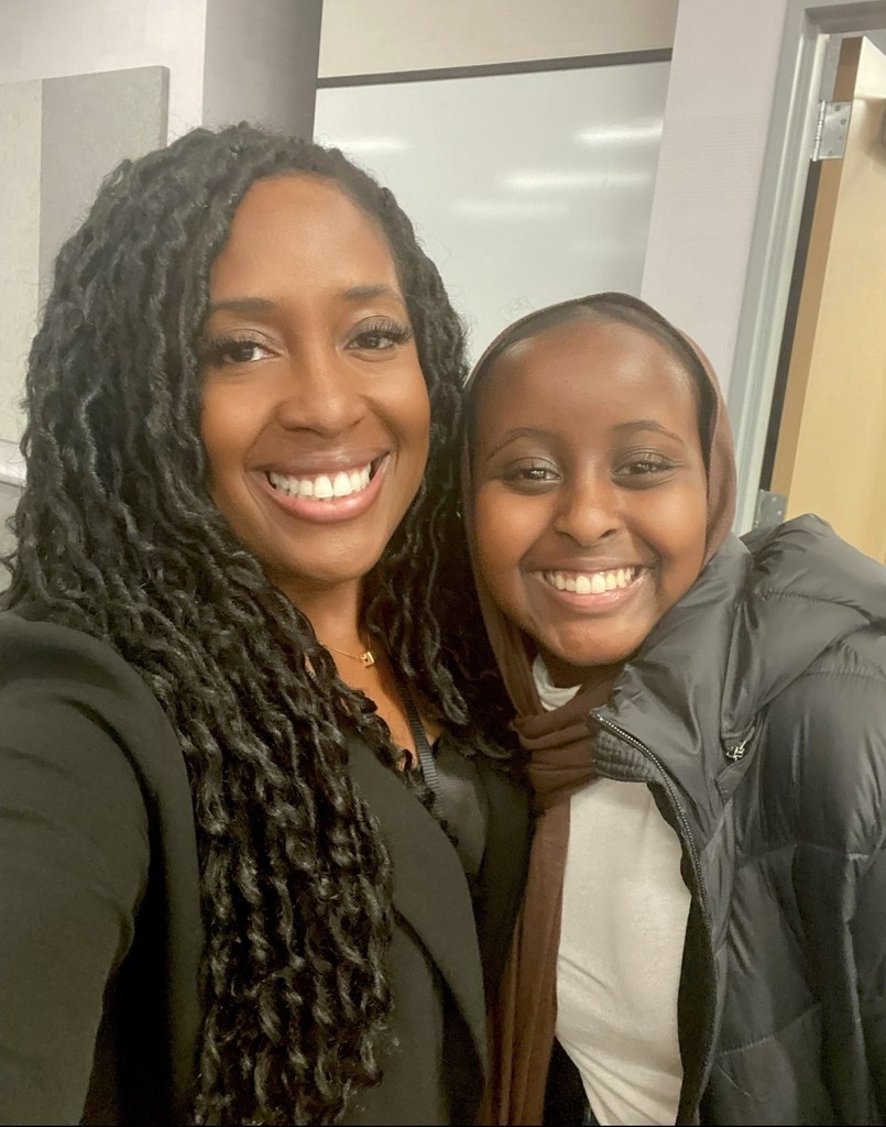 Sara Louise Henry posing with a student