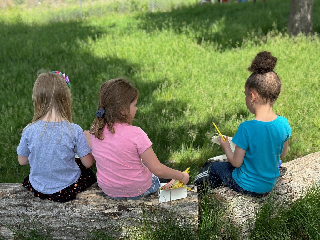3 kids sitting on a log
