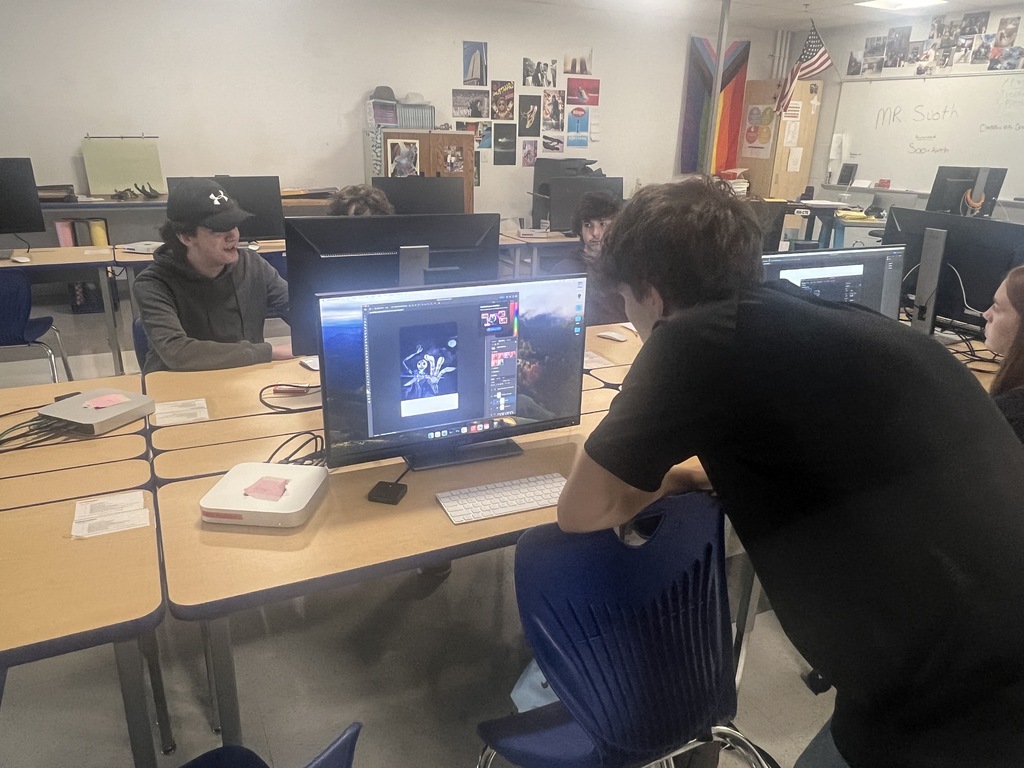 Photo/video students working on a poster project 
