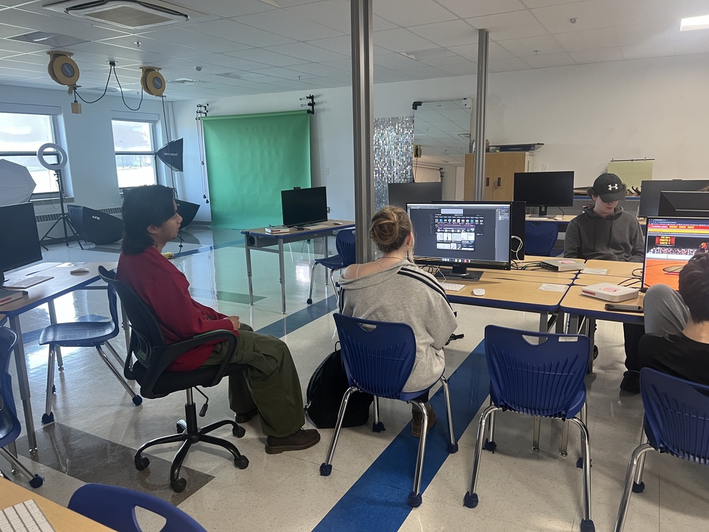 Photo/video students working on a poster project 