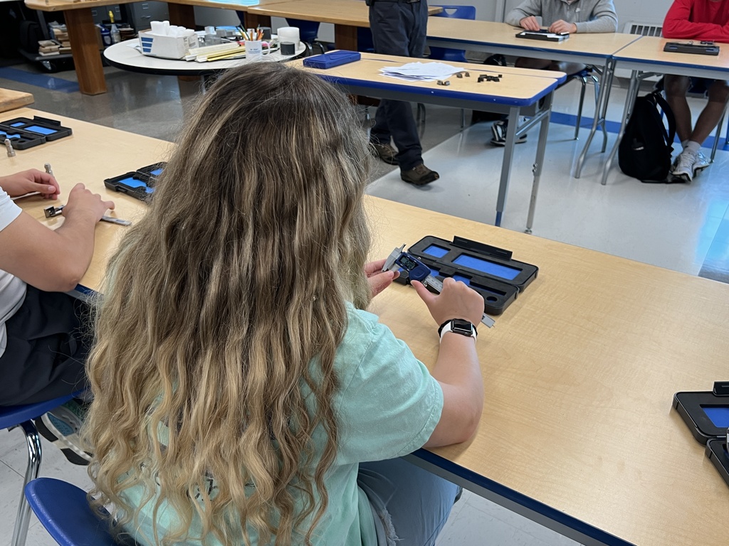 Engineering students calibrating tools 