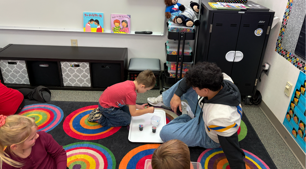 Football Player and kindergartner play math game.