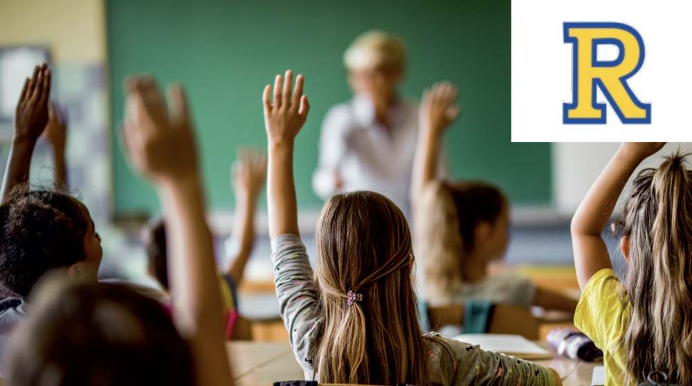 students raising hands in class