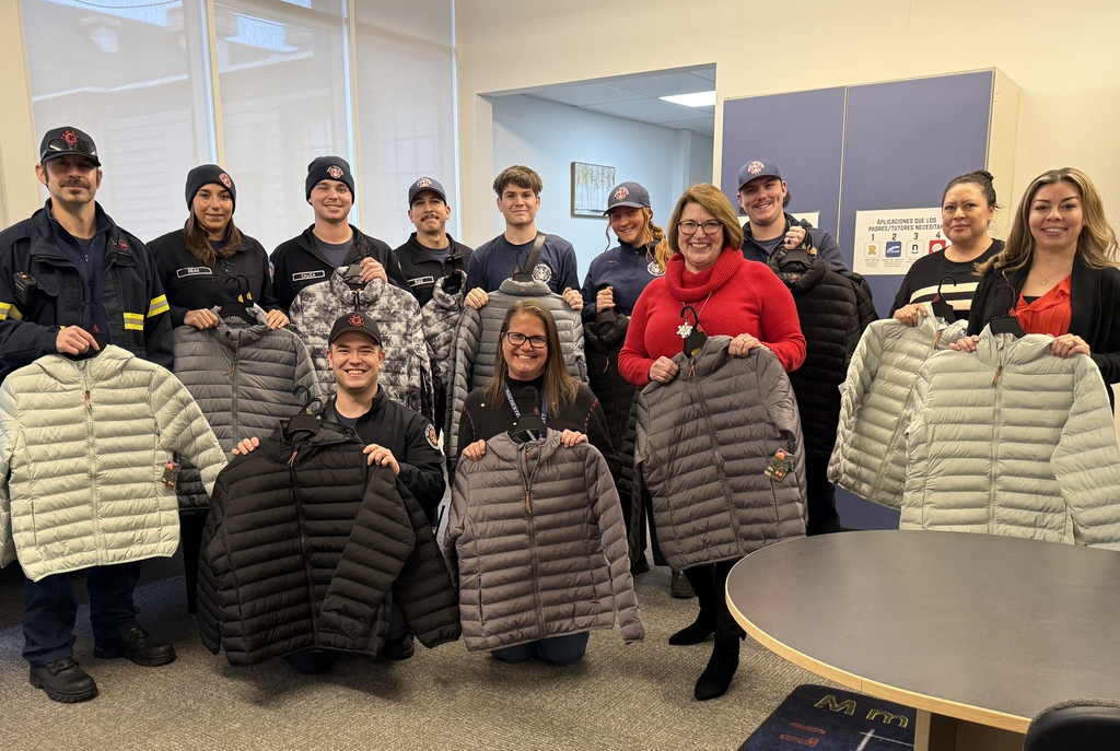 Picture of fire department team donating coats for teens