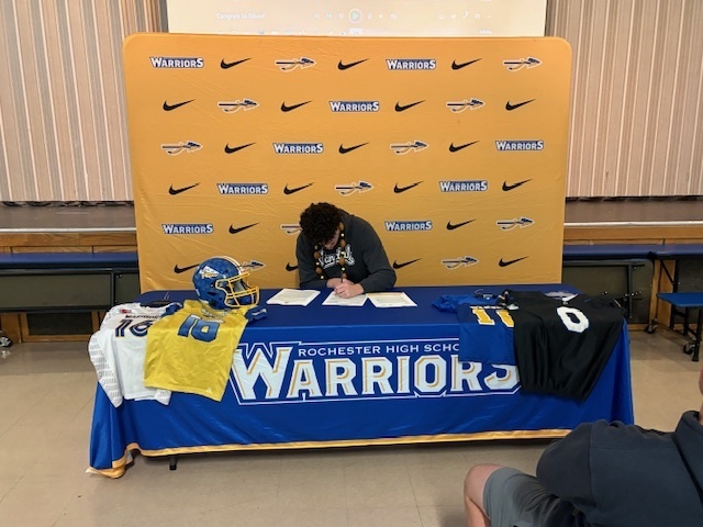 Student signing document