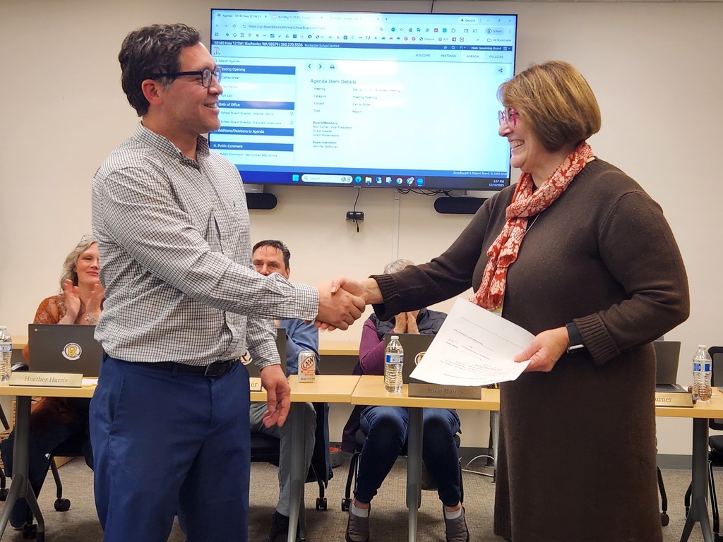 Man and woman shaking hands.