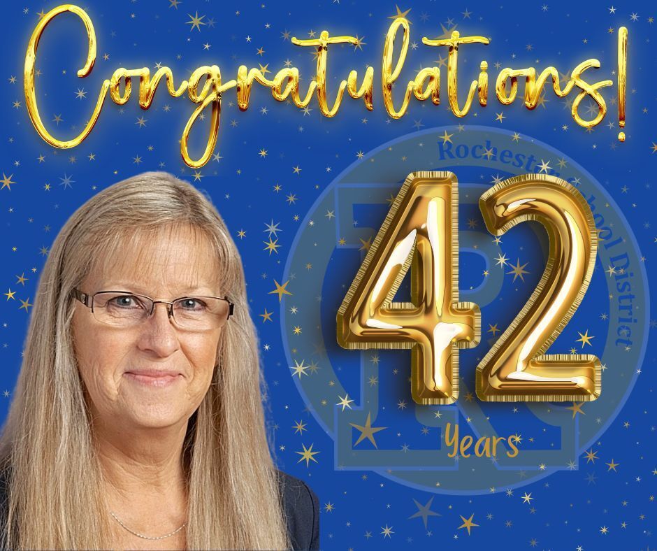 A smiling woman with long blonde hair and glasses stands against a blue background. Gold numbers 42 and text "42 Years" and "Congratulations!" are in gold foil.