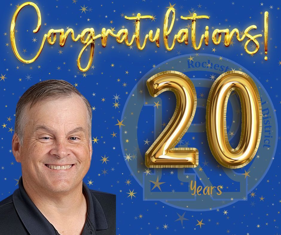 Man smiling in front of a blue background. A golden number 20 appears above him. Text reads "Congratulations! 20 years".