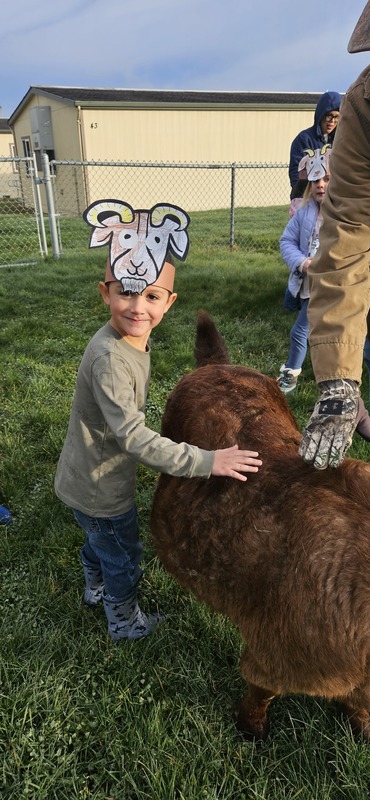 Student petting goat.