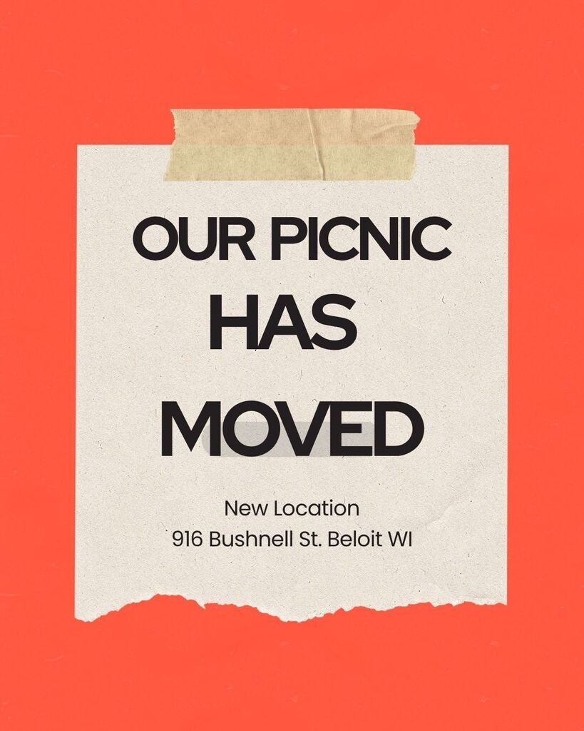 Red sign with tape stating that our picnic has moved