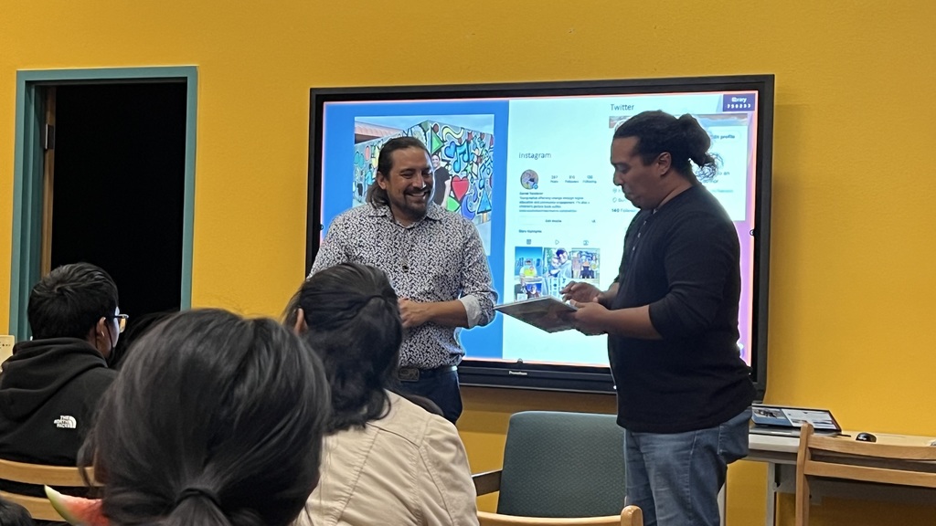 Vandever being presented with a book written by RPCS students.