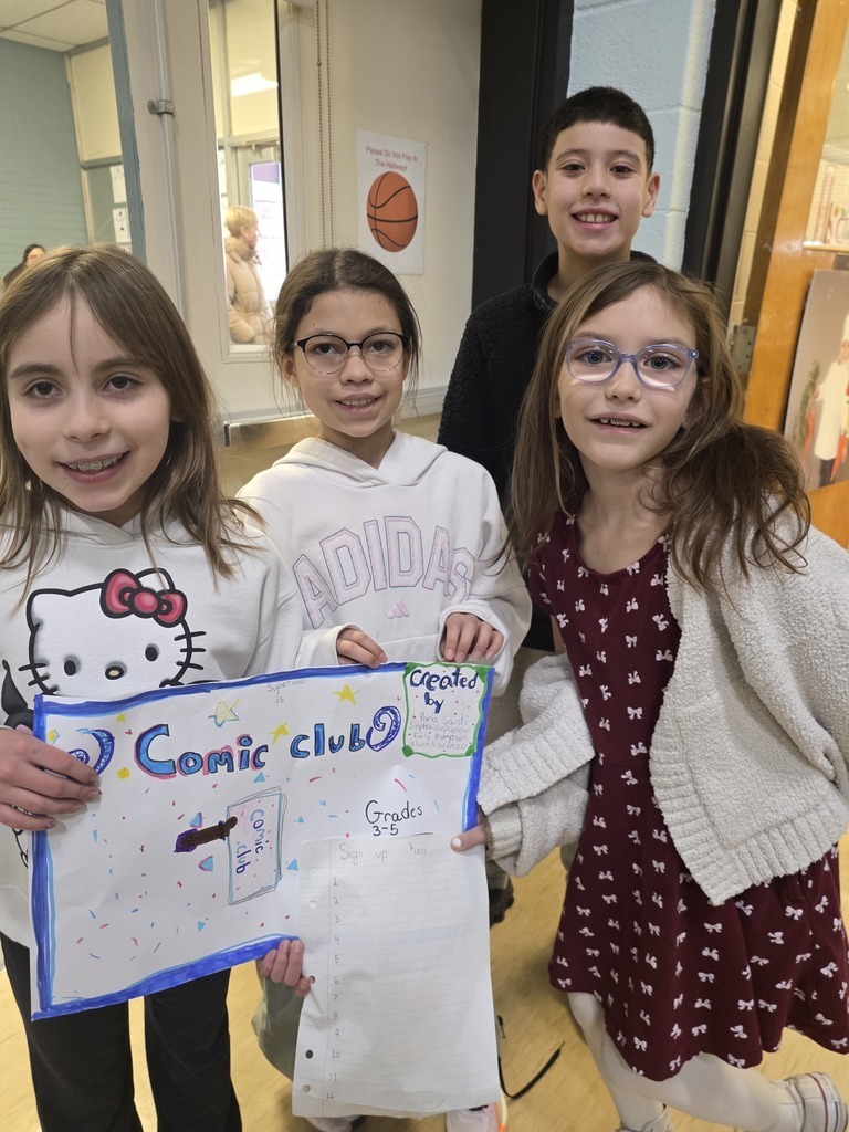 4 students posing with a poster that reads comic club -share your ideas 