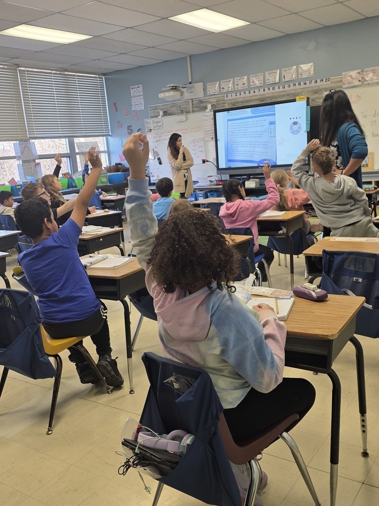students faing the teacher and raising their hands -  regular day at our Home Away from Home... 